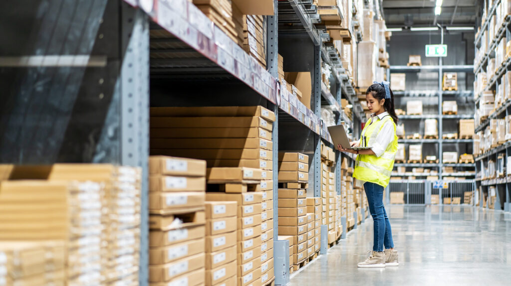 Organized warehouse with product shelves and pallet racks tracked by ERP inventory system